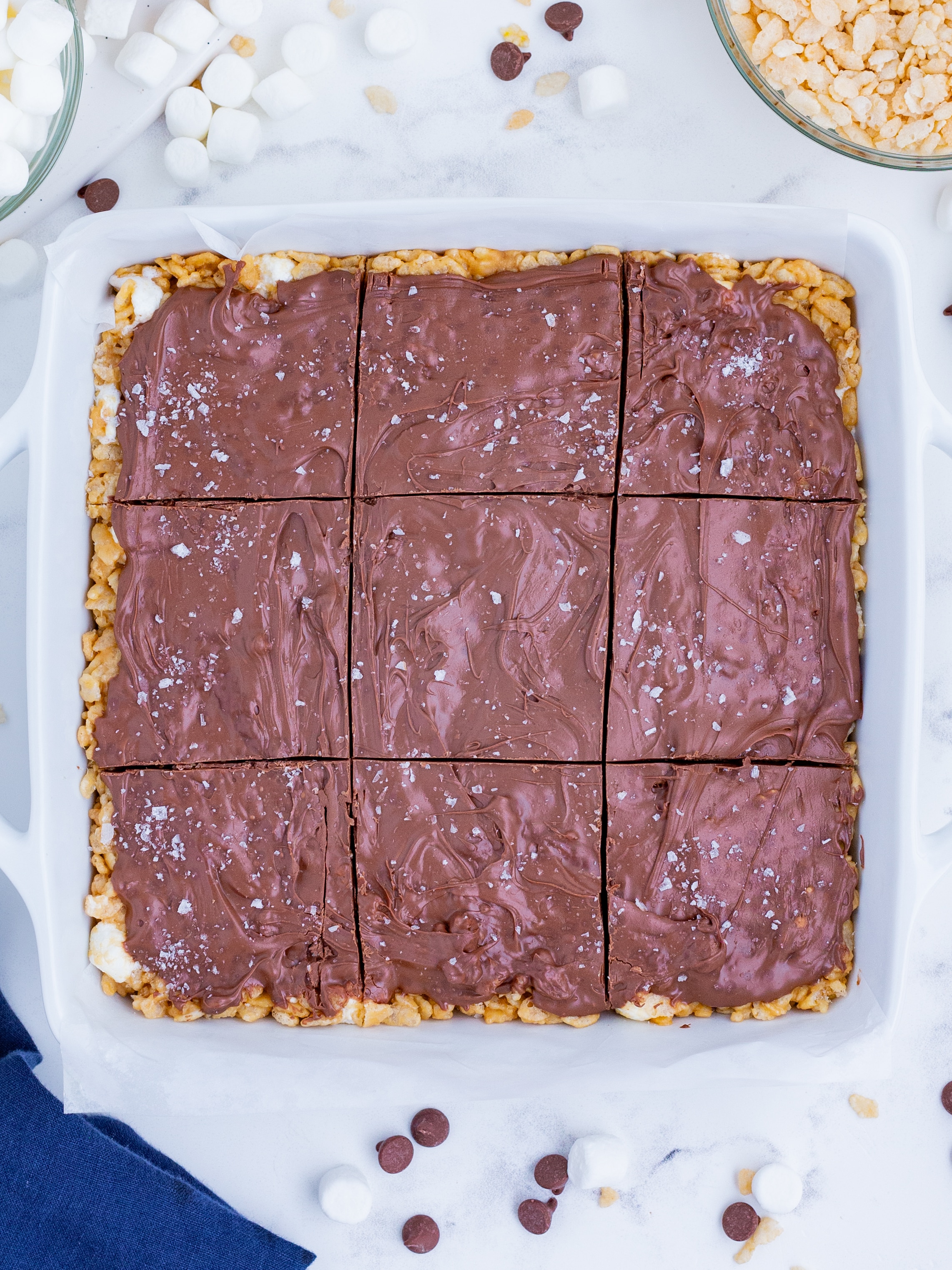 A tray of PB rice krispie treats are cut into squares.