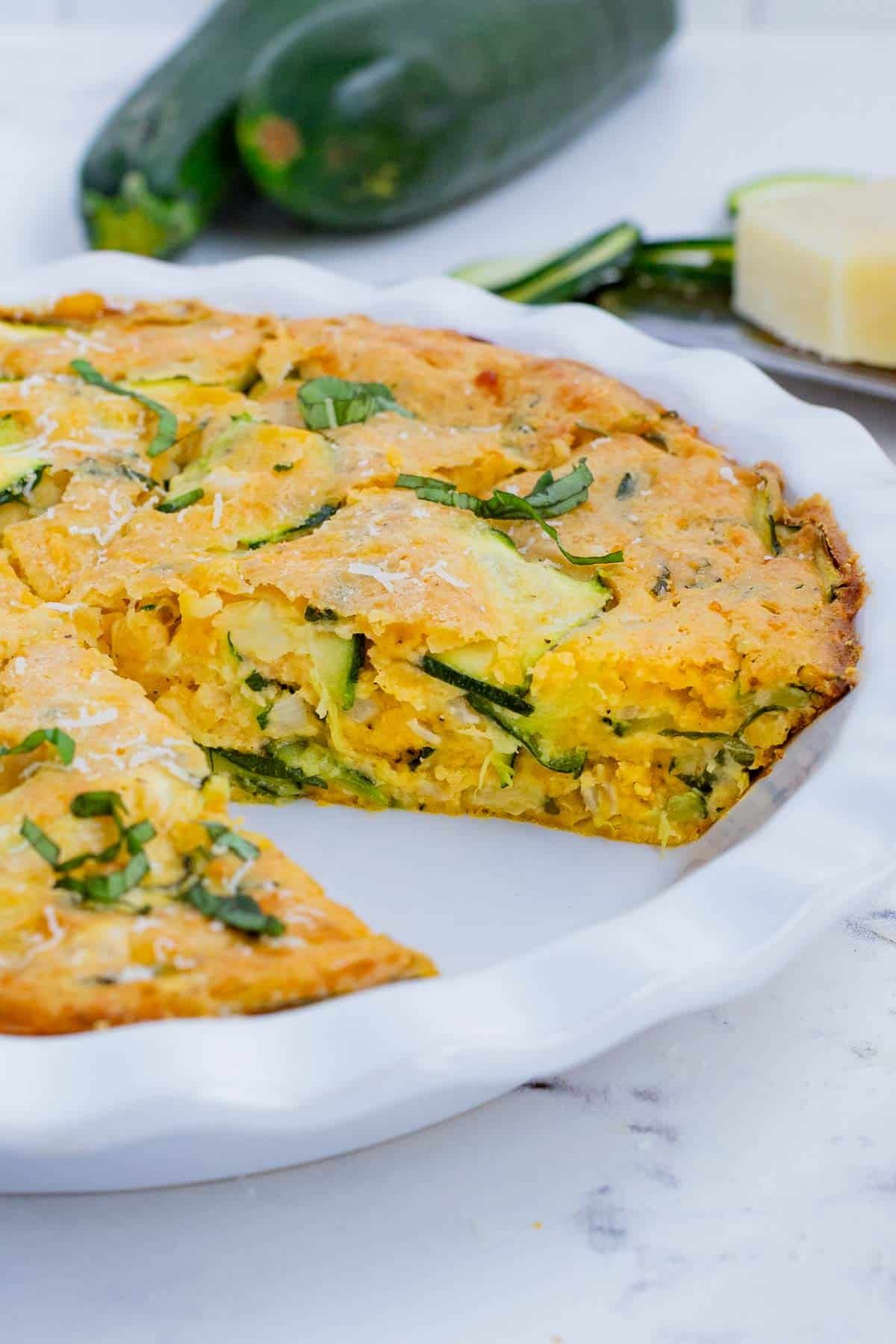 Zucchini pie is made with zucchini, cheese, herbs, and eggs.