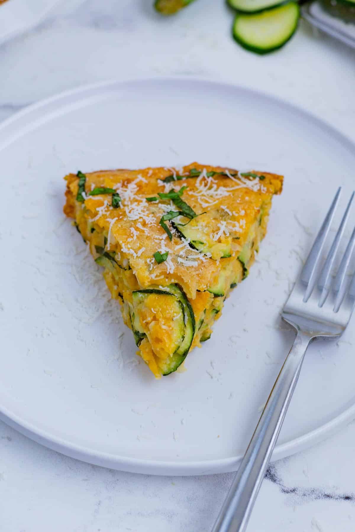 Zucchini pie is a savory and cheesy side dish you can easily whip up at home.