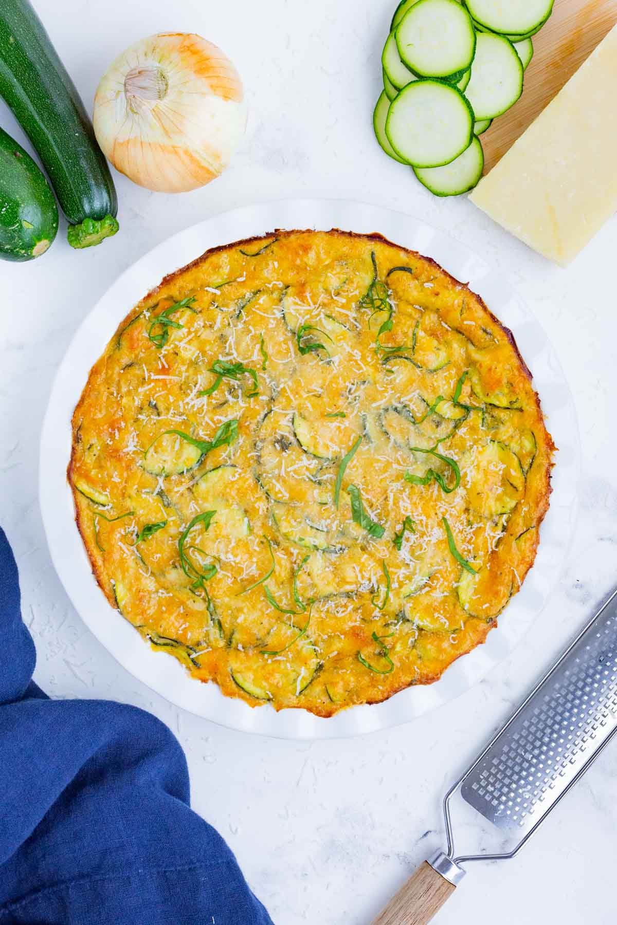 Zucchini pie is a savory and cheesy side dish you can easily whip up at home.