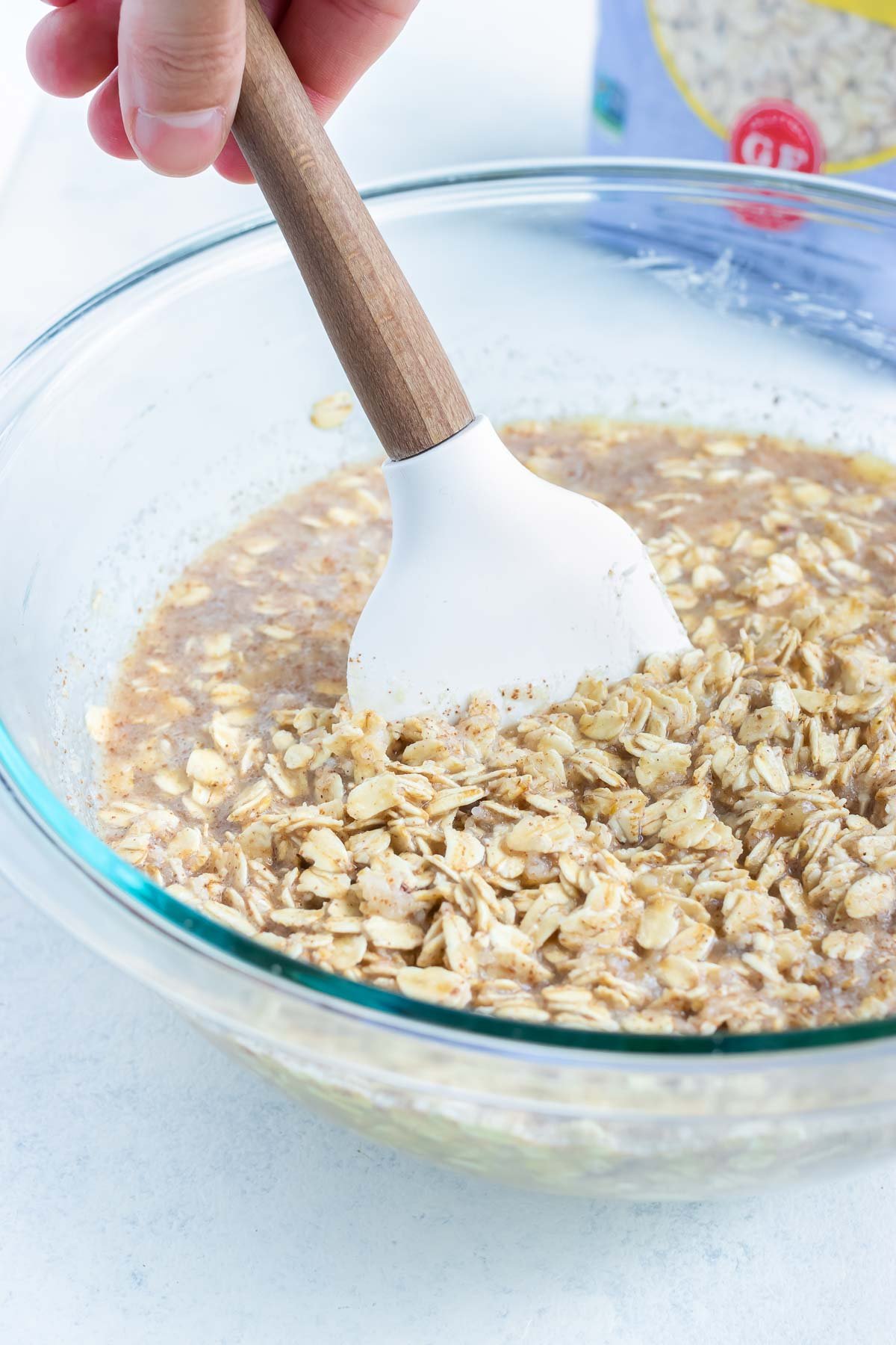 The nuts are mixed into the mixture in a bowl.