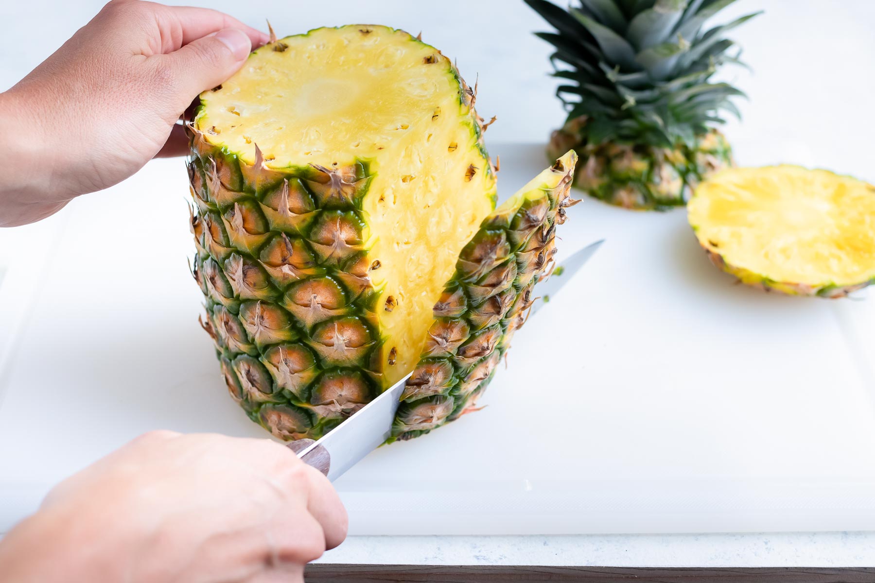 The side skin of the pineapple is cut off.