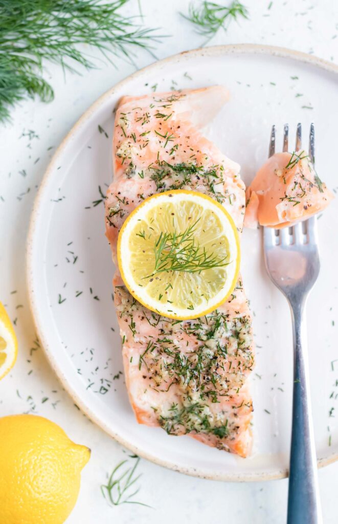 A fork is used to eat healthy salmon dish for dinner.