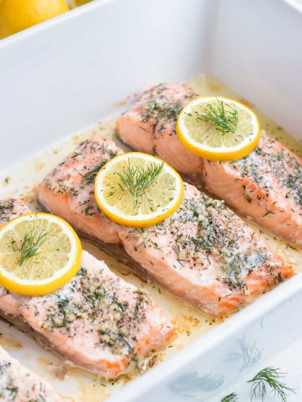 Lemon dill salmon is baked in the oven in a dish.