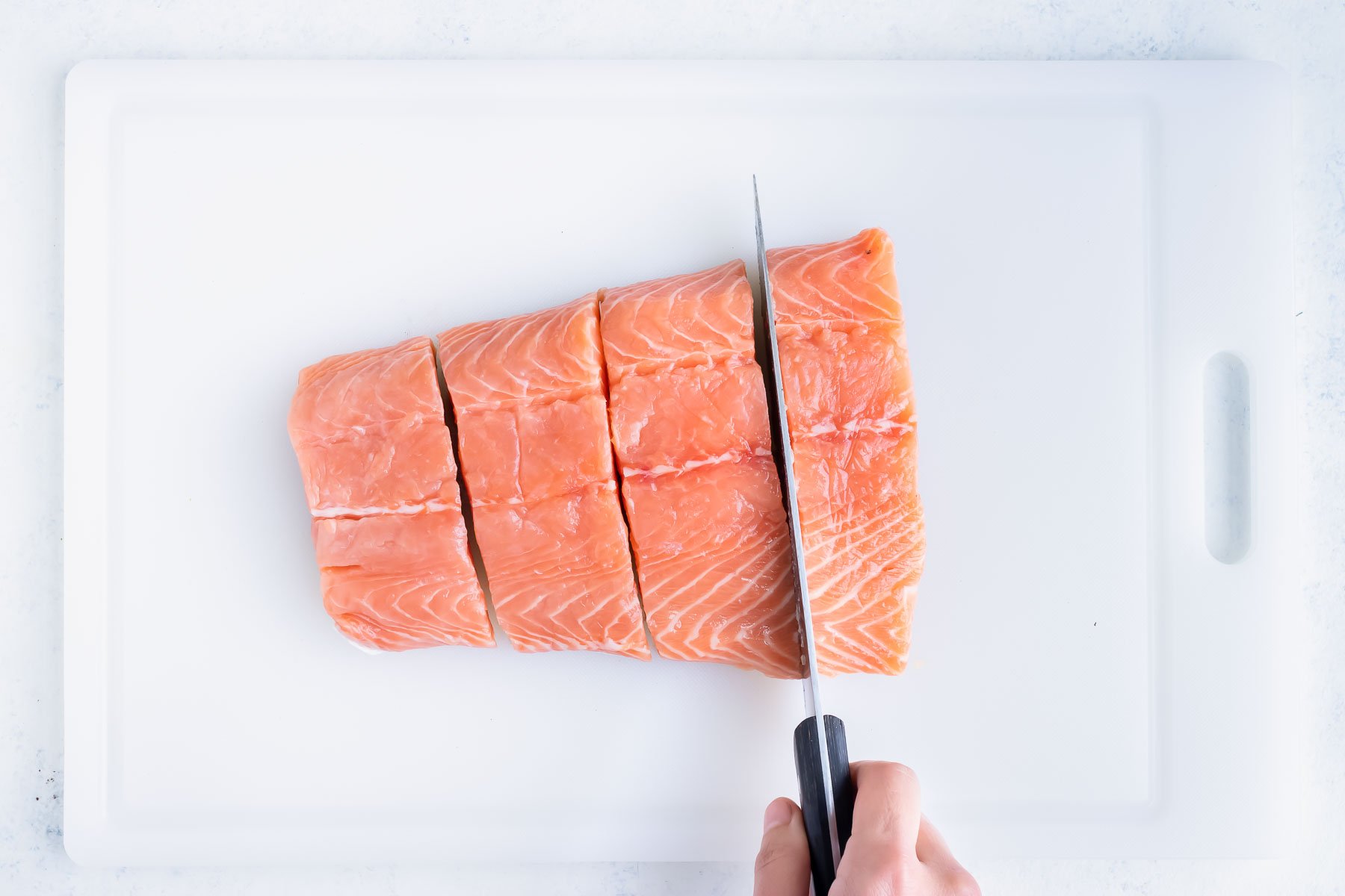 One pound of salmon is cut into four pieces.