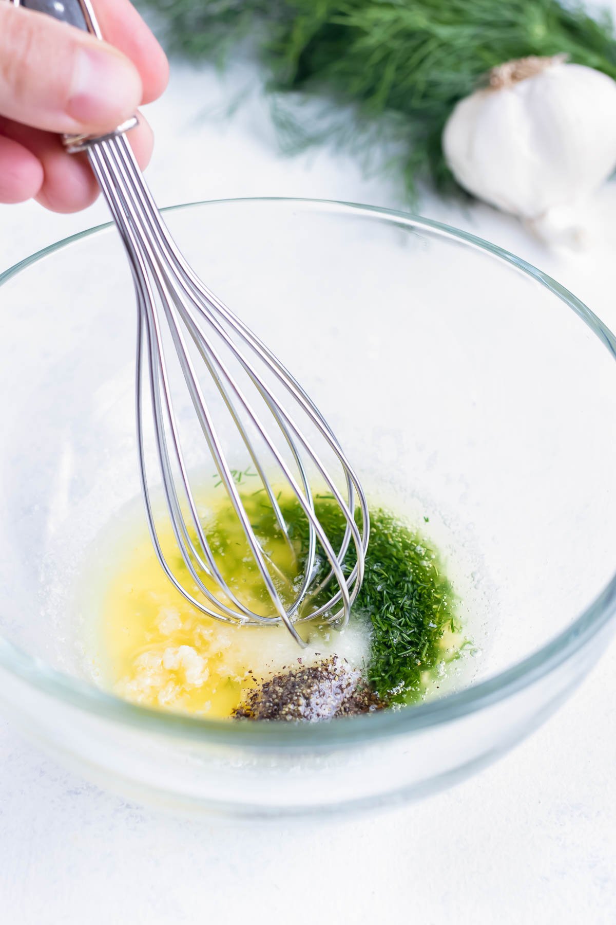 Melted butter, lemon juice, chopped dill, salt and pepper are combined in a bowl.