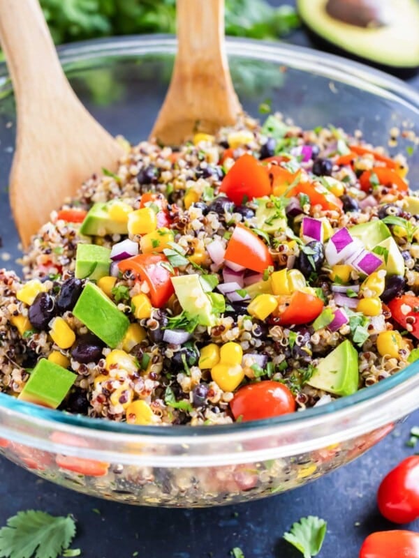 A Mexican Quinoa Salad with avocado is served in a bowl with a homemade cilantro lime dressing.