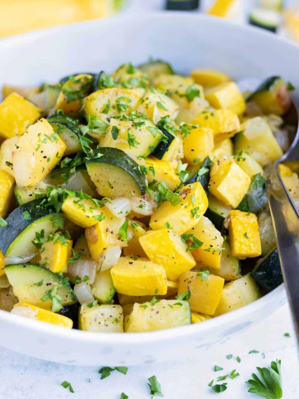 Cooked zucchini and squash with parsley sprinkled on top.