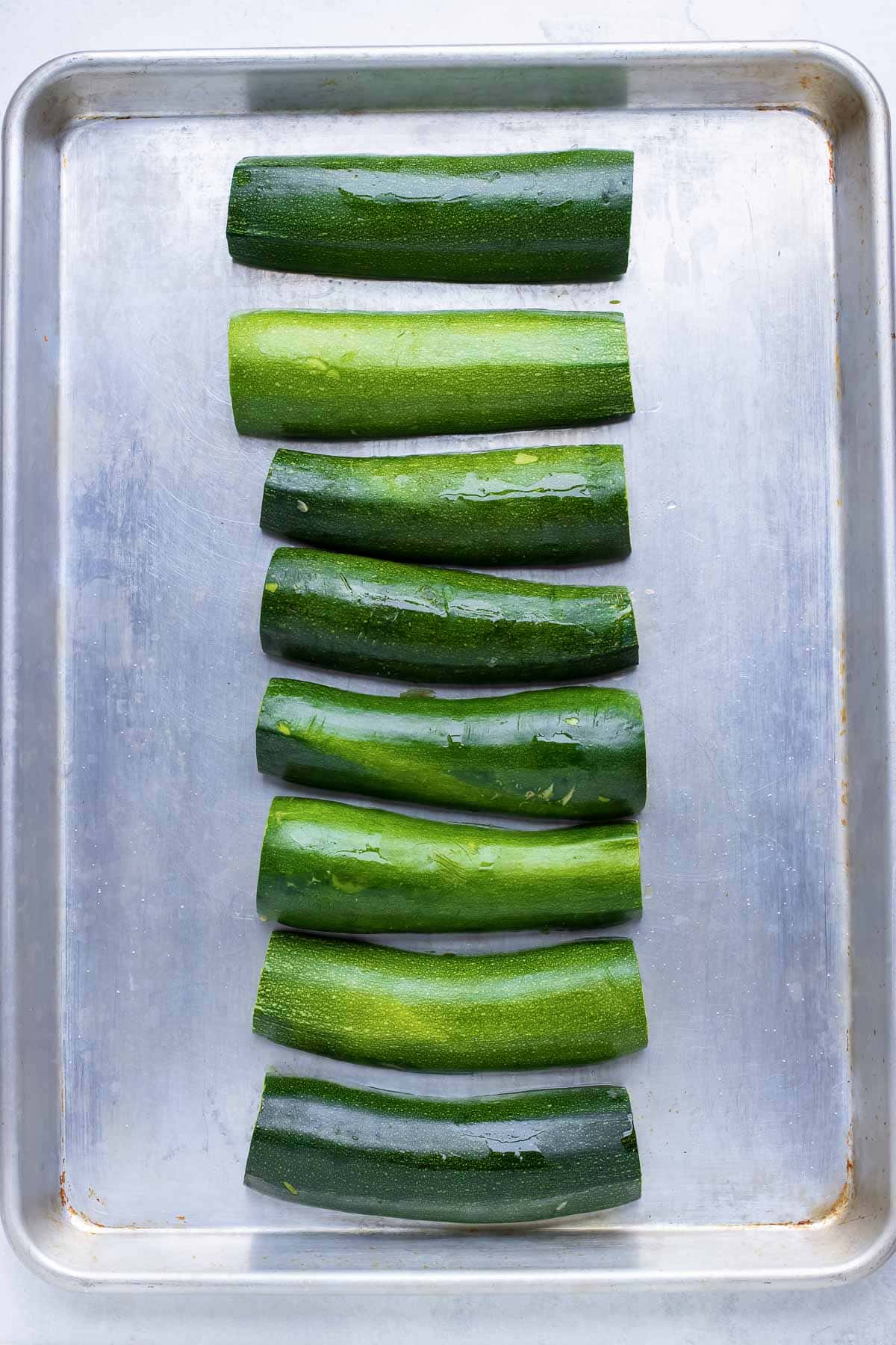 Prepared zucchini are prebaked before stuffing.