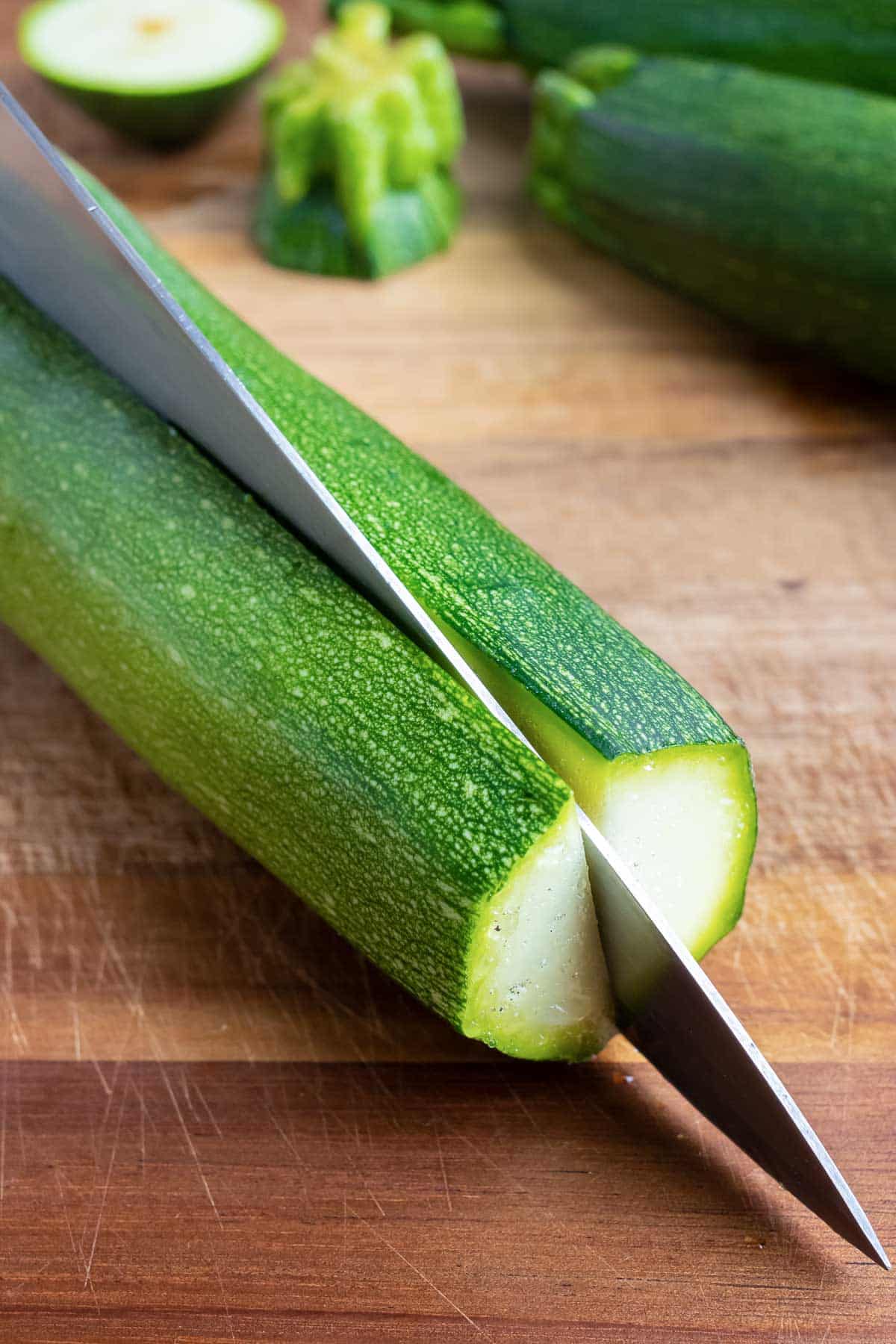 A zucchini is cut in half longways.