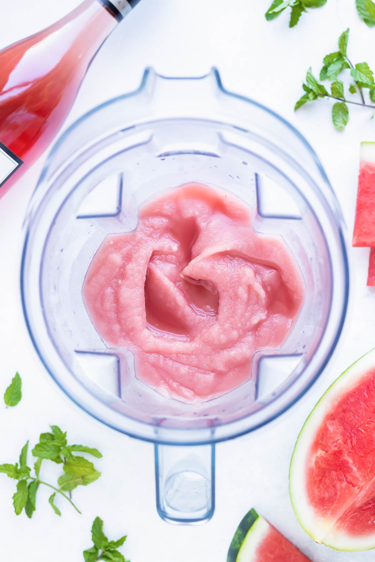 A blended cocktail recipe in a vitamix showing how to make frosé.