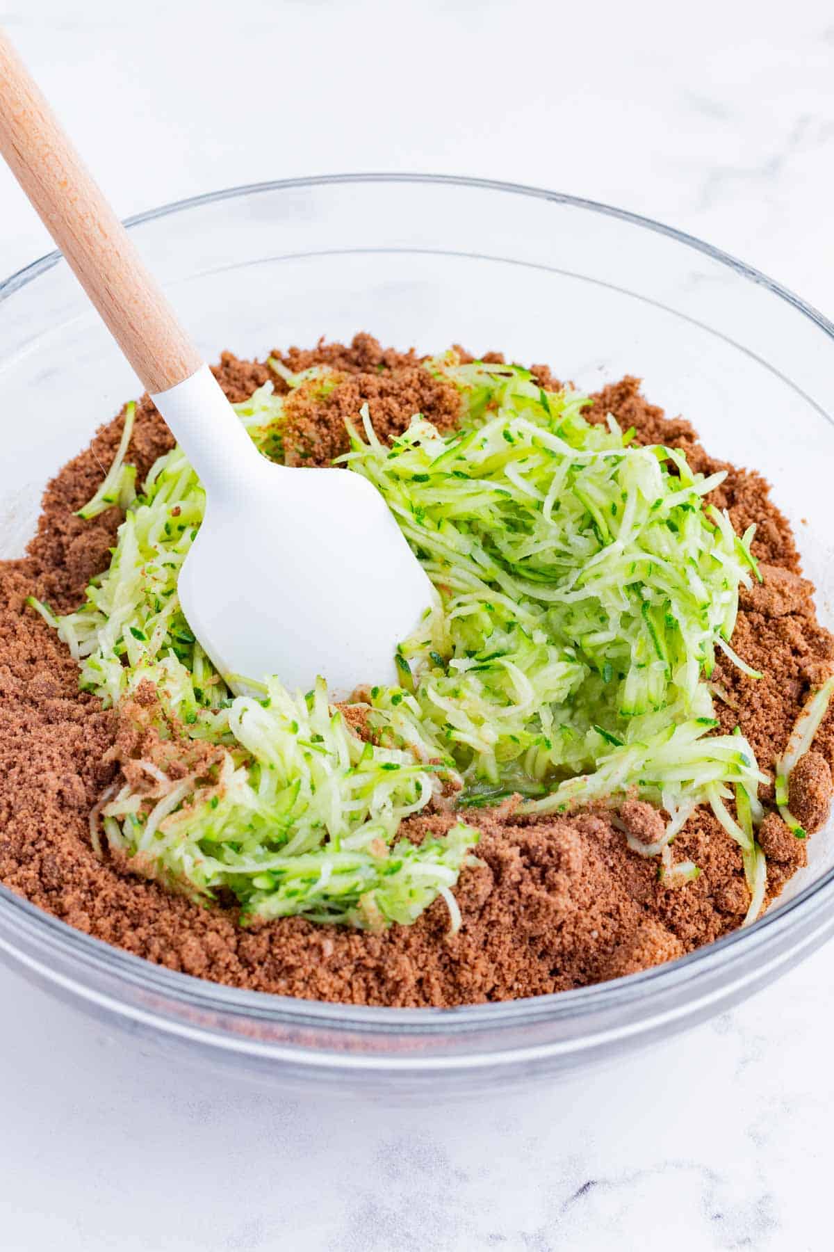 Shredded zucchini and flour is stirred into the brownie batter.