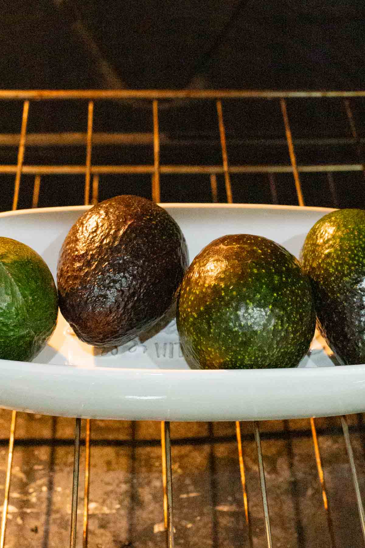 4 avocados in an oven.