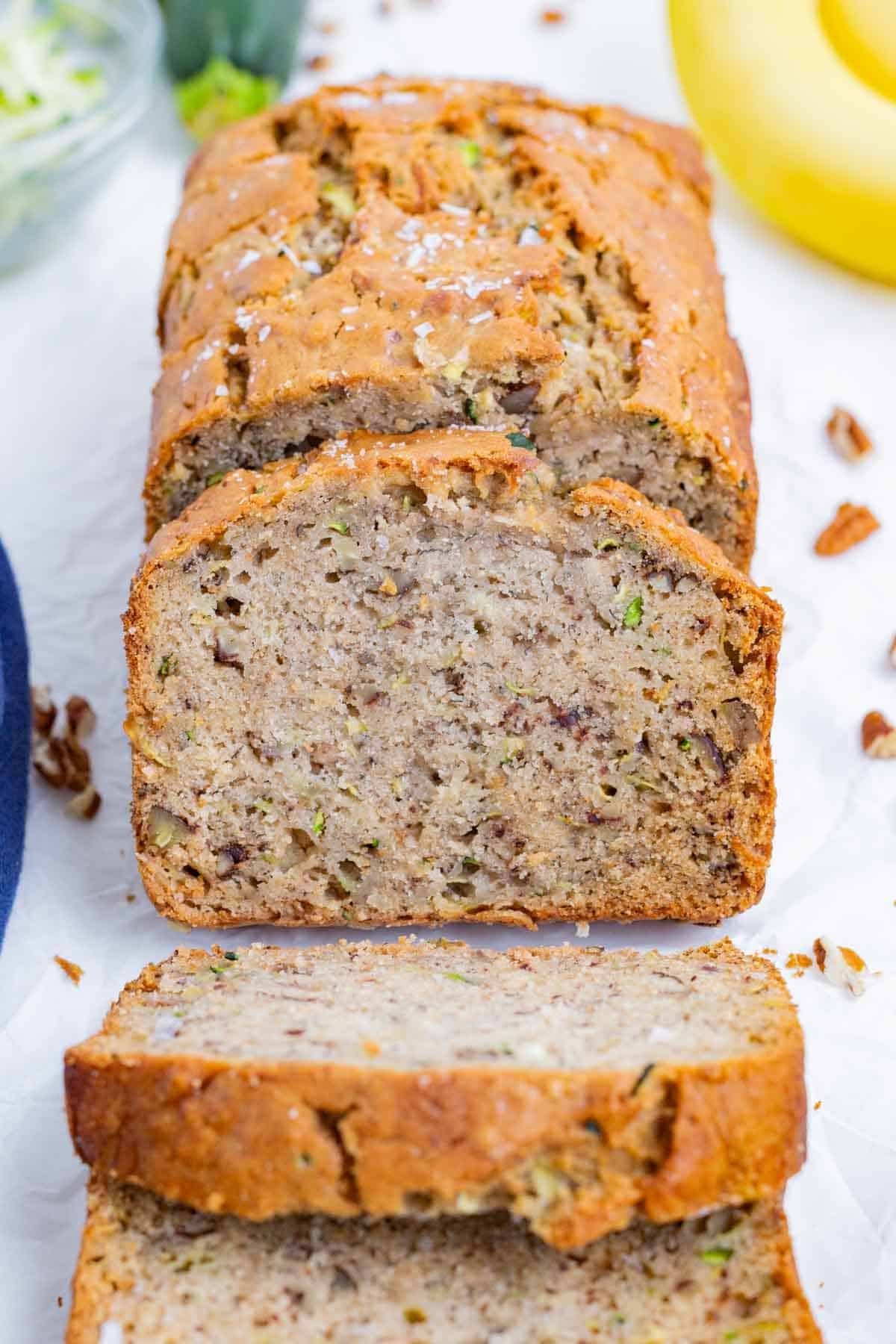 The end of a loaf of zucchini banana bread is being sliced.