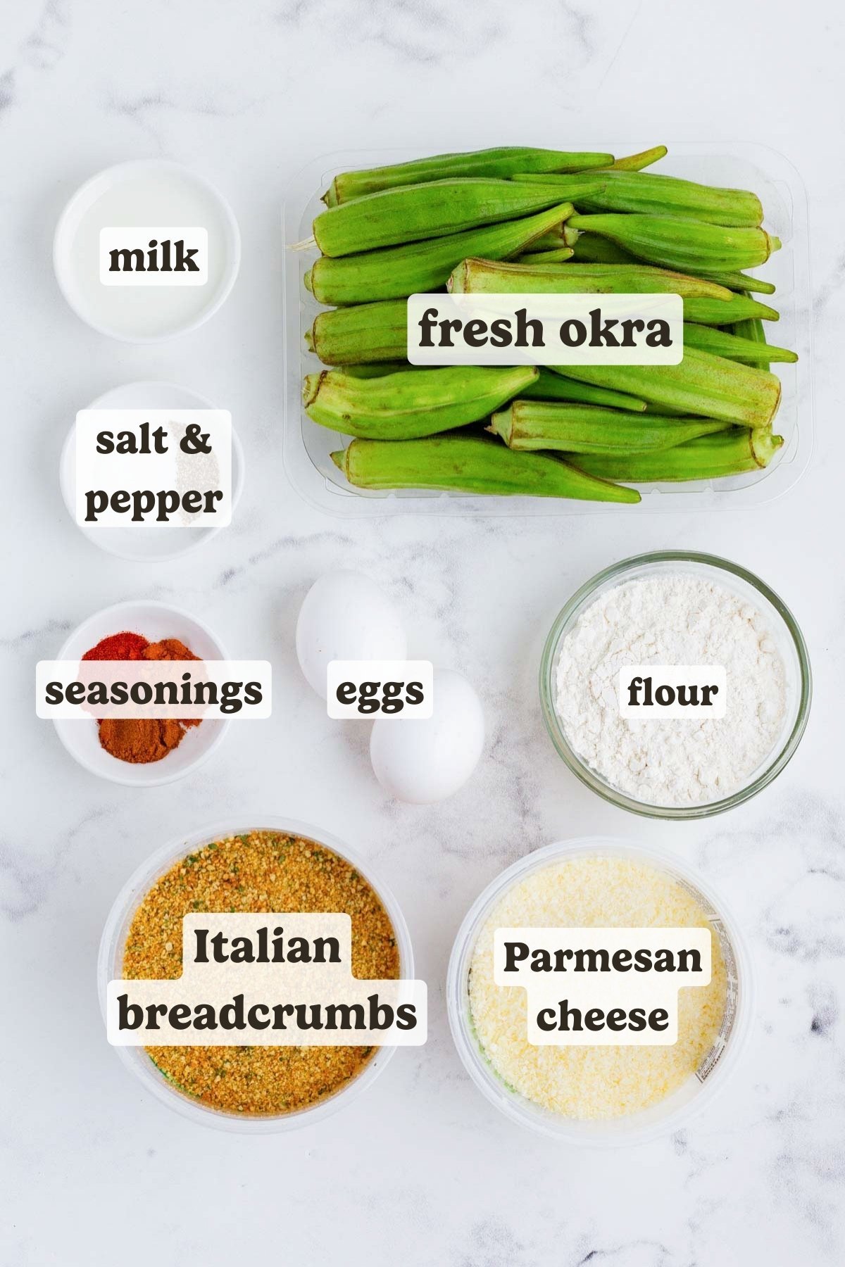 Fresh okra, milk, eggs, breadcrumbs, and Parmesan cheese on a table to make an air fryer okra recipe.