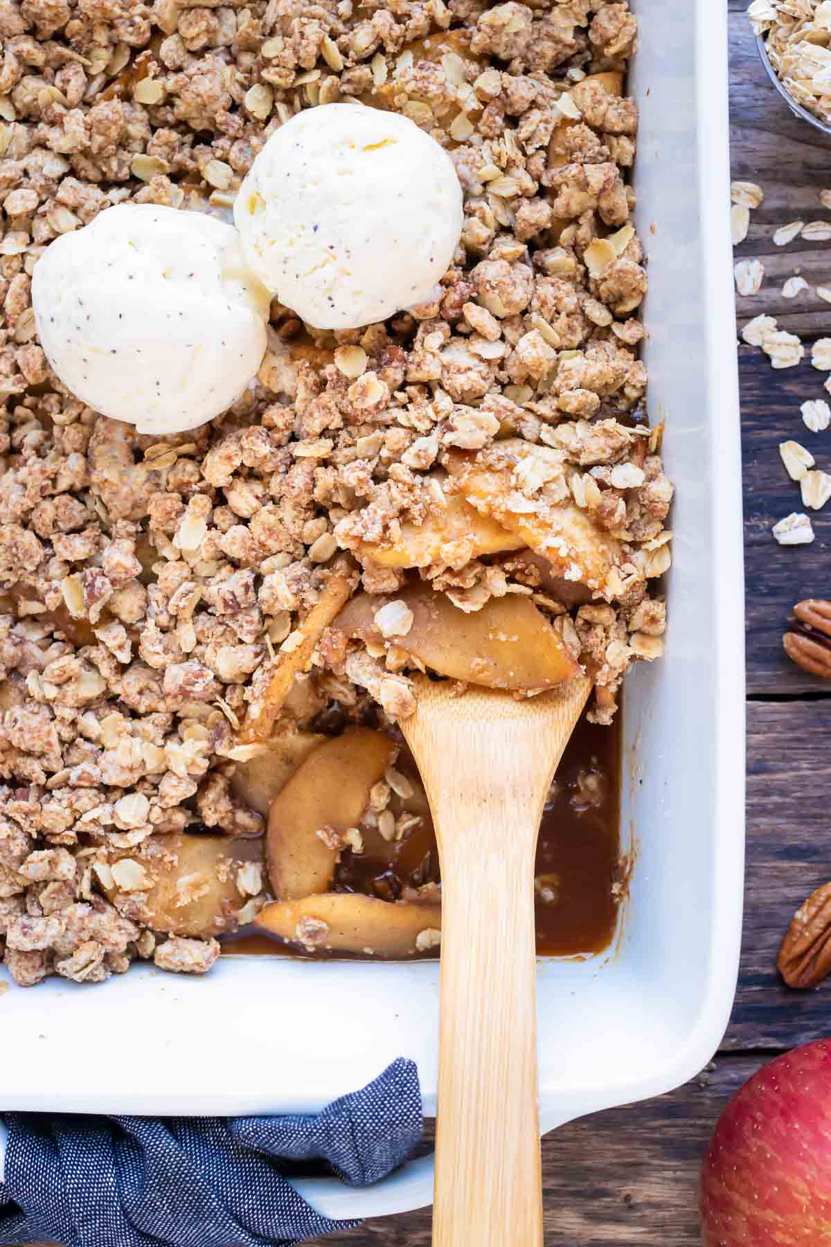 A healthy and gluten-free apple crisp recipe with two scoops of ice cream in a baking dish.