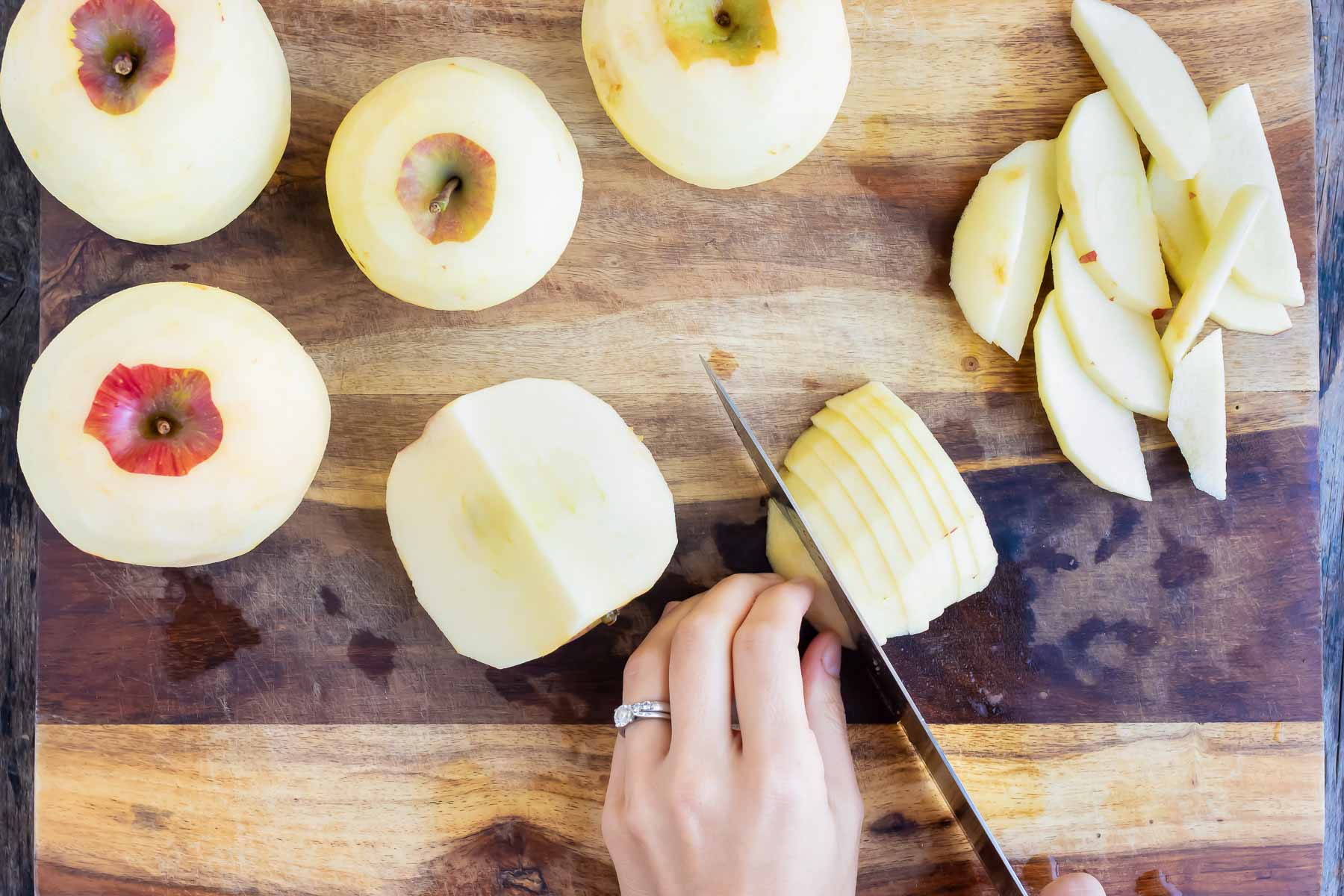 An apple is cored and sliced.