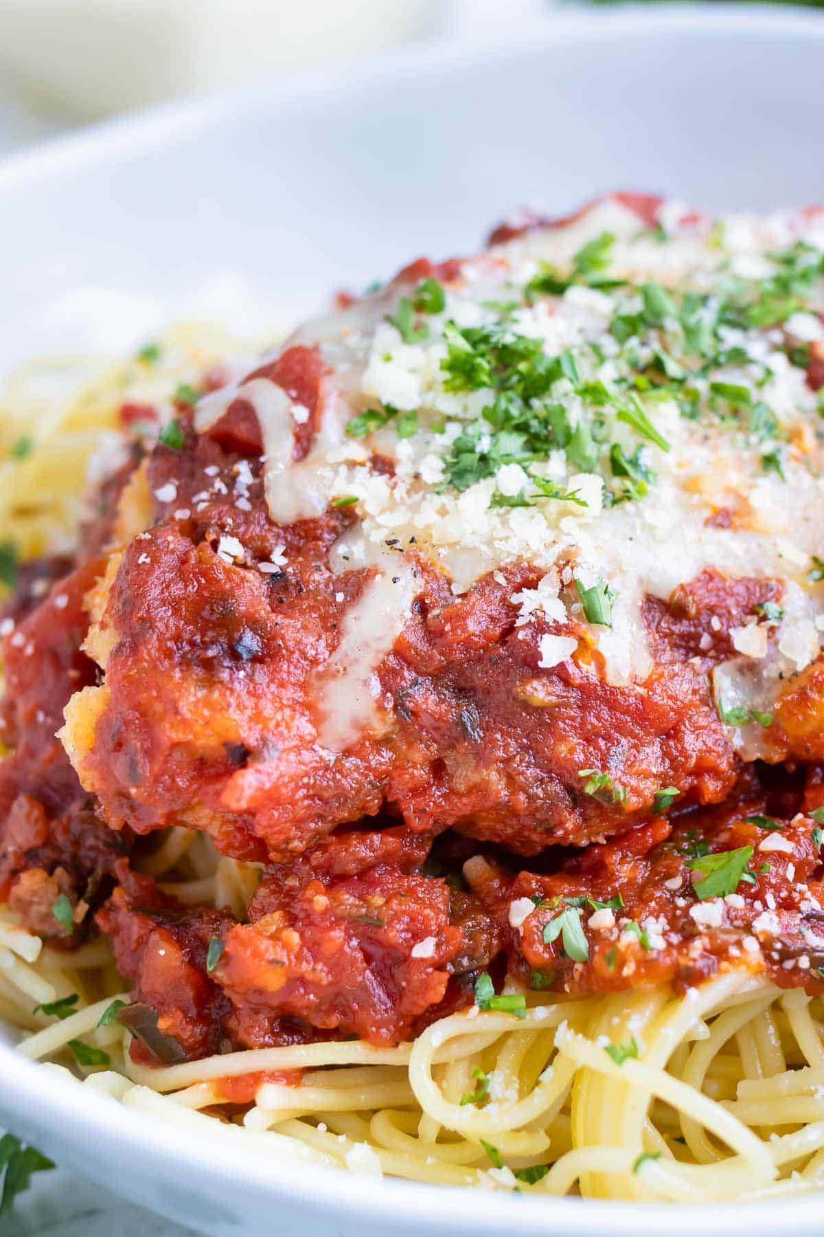Serve gluten-free chicken parmesan over spaghetti for a kids approved dinner.
