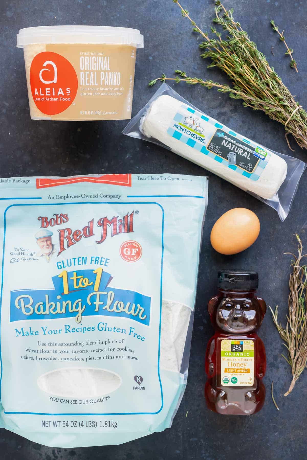 Goat cheese, herbs, honey, Panko breadcrumbs, flour, and an egg as the ingredients for a fried goat cheese recipe.