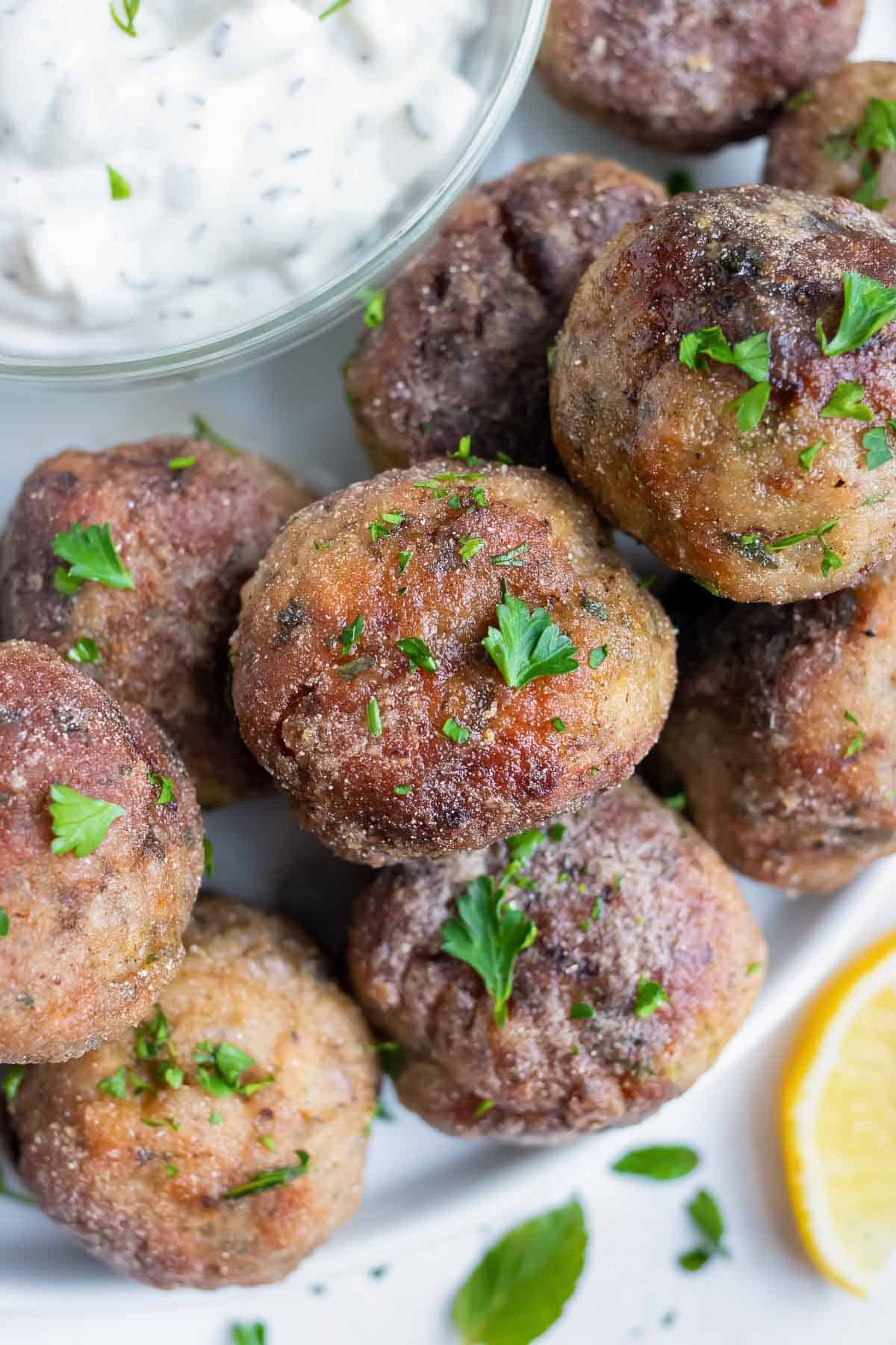 Top finished meatballs with a fresh mint leaves in this Mediterranean meatball recipe.