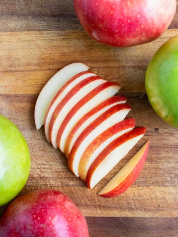 Fresh apple slices are laid on the counter before adding to apple pie or oatmeal.