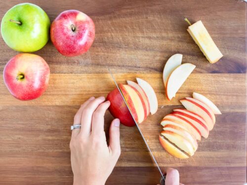Showing the best way to cut apples into even slices.