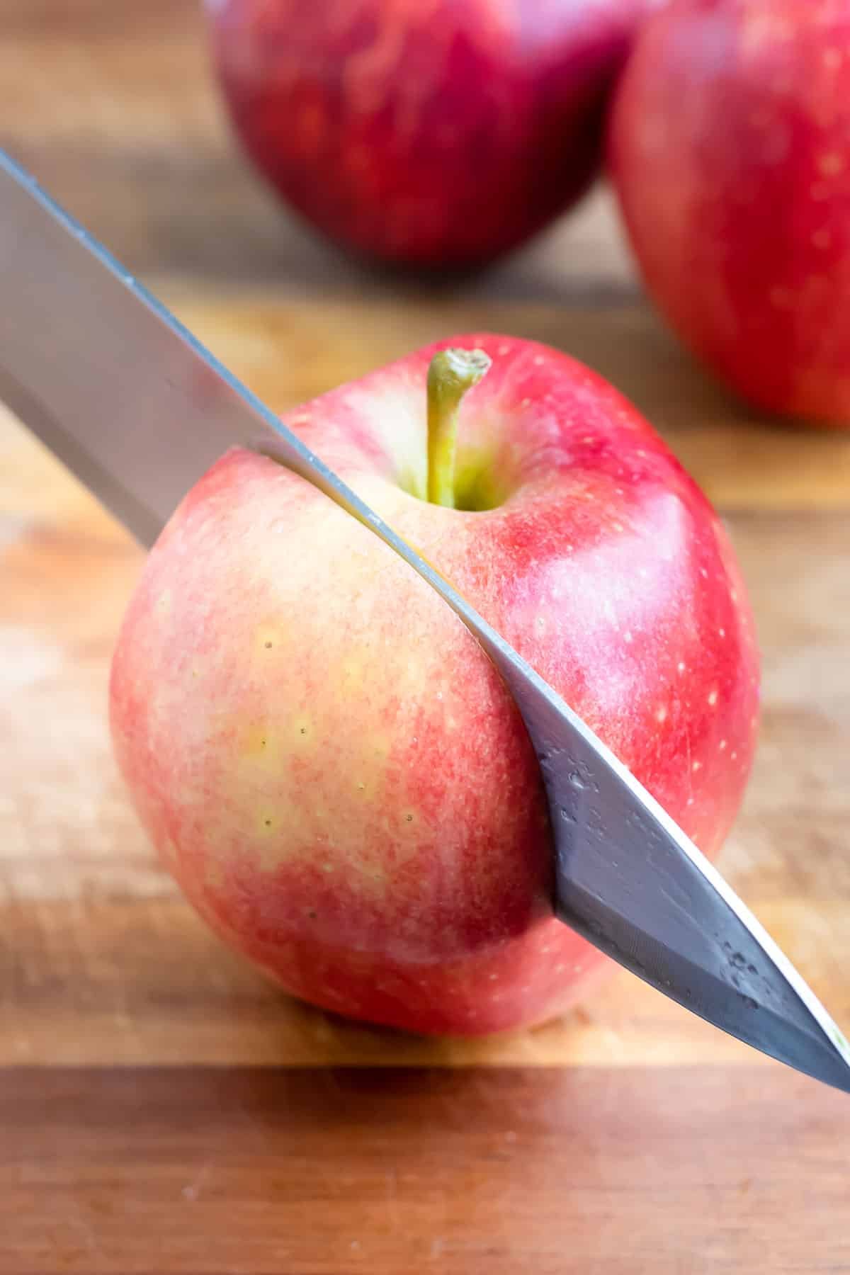 The best way to cut an apple is by coring and then cutting into apple slices.