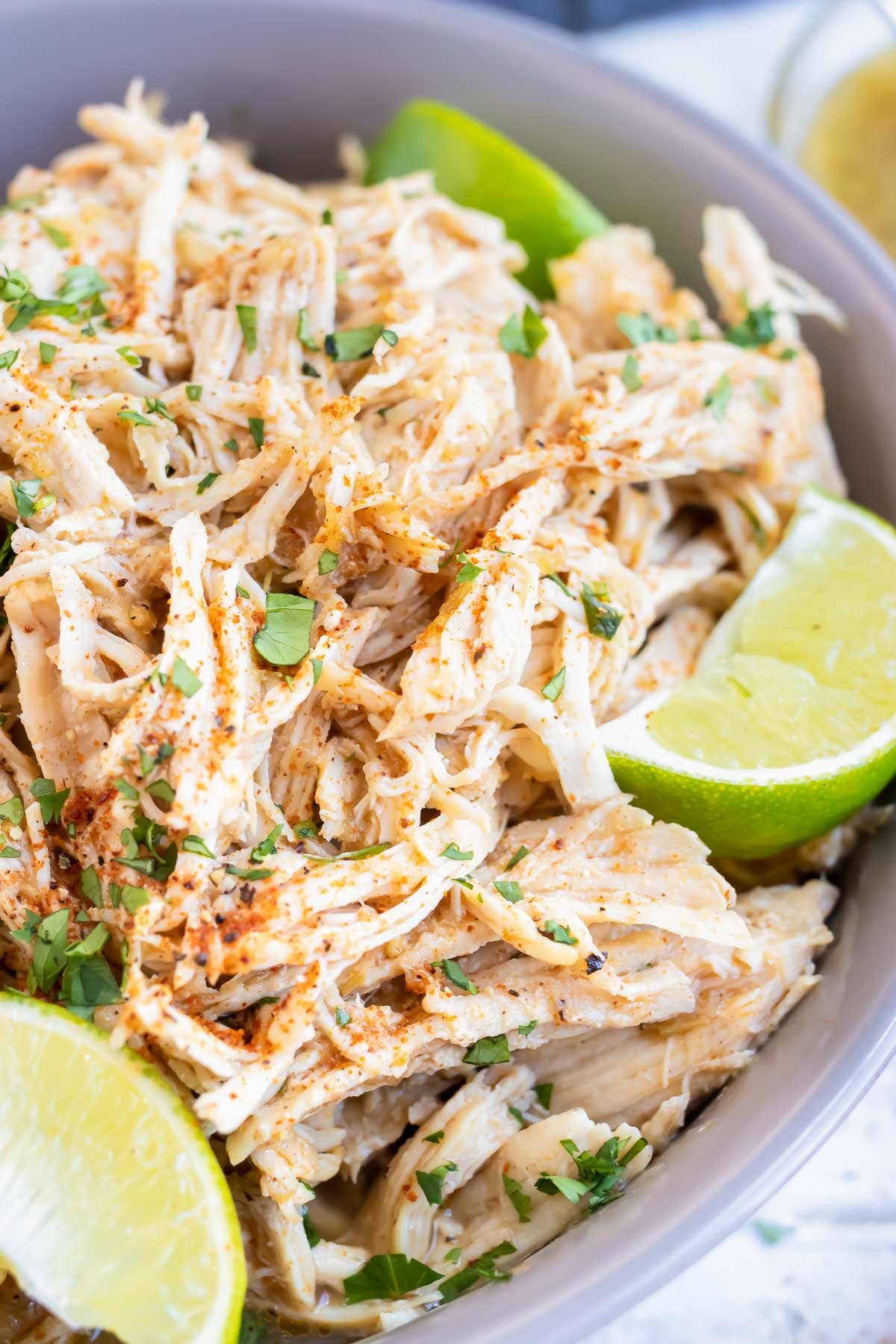 Tender, shredded chicken breasts in a bowl.