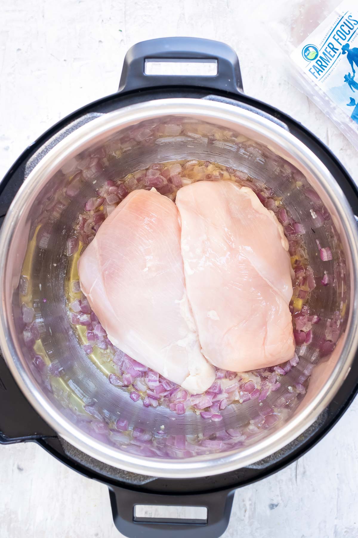 Chicken is placed in the Instant Pot.