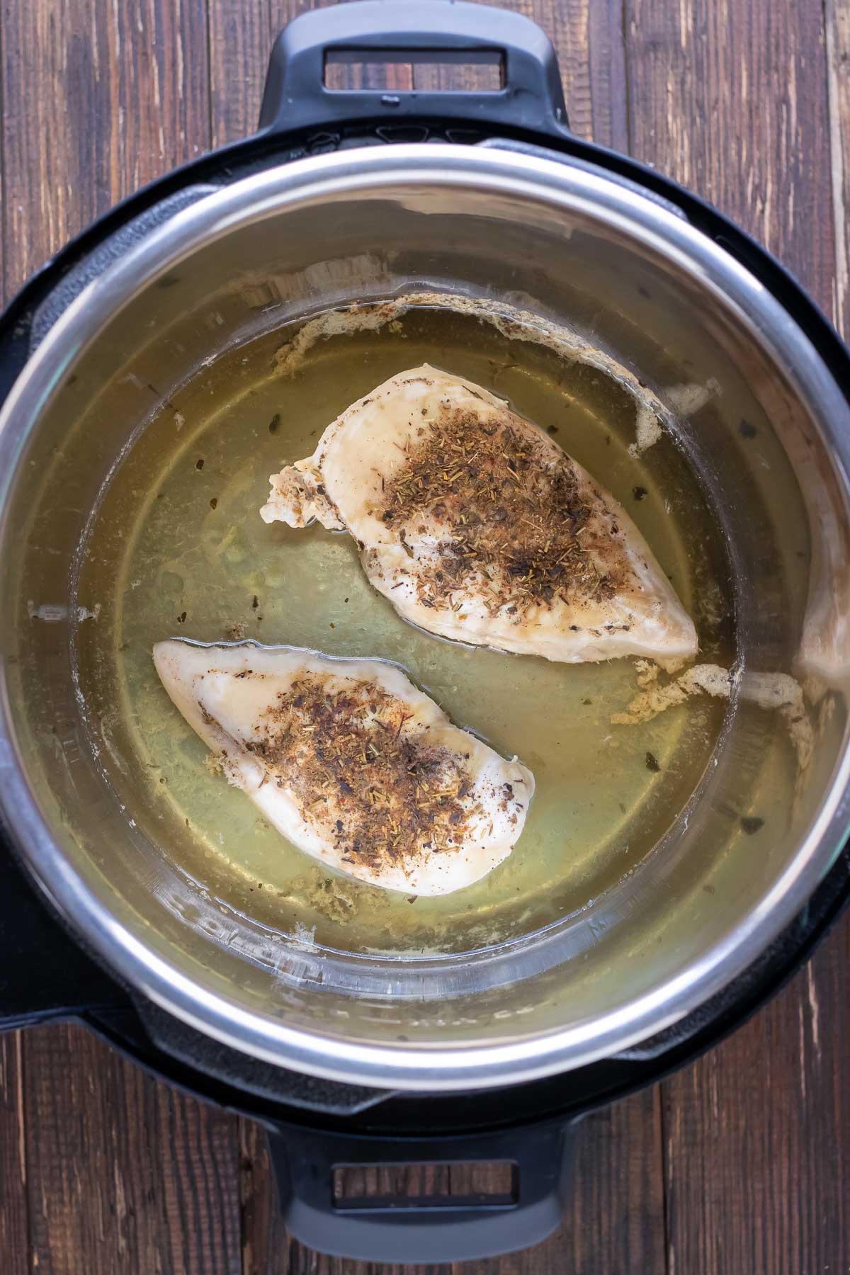 Cooked chicken breasts are ready in the pressure cooker.