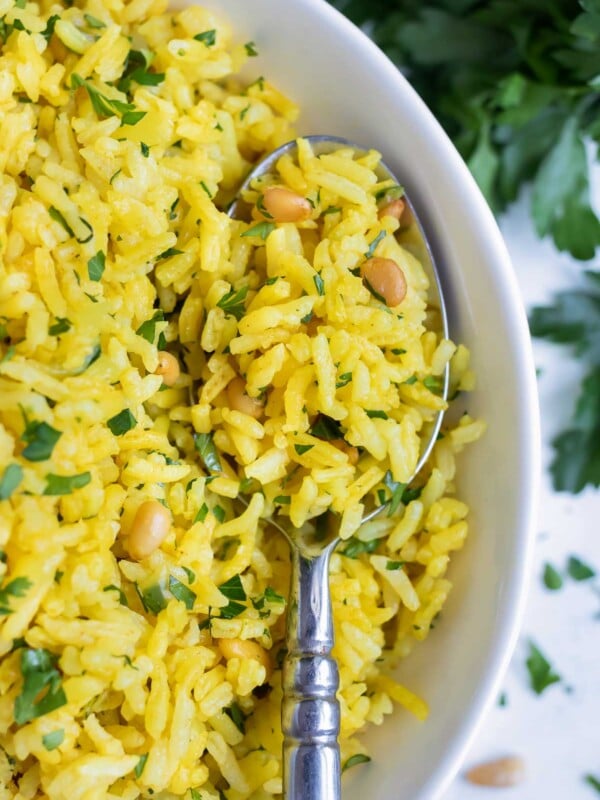 Mediterranean rice is served with a metal spoon.