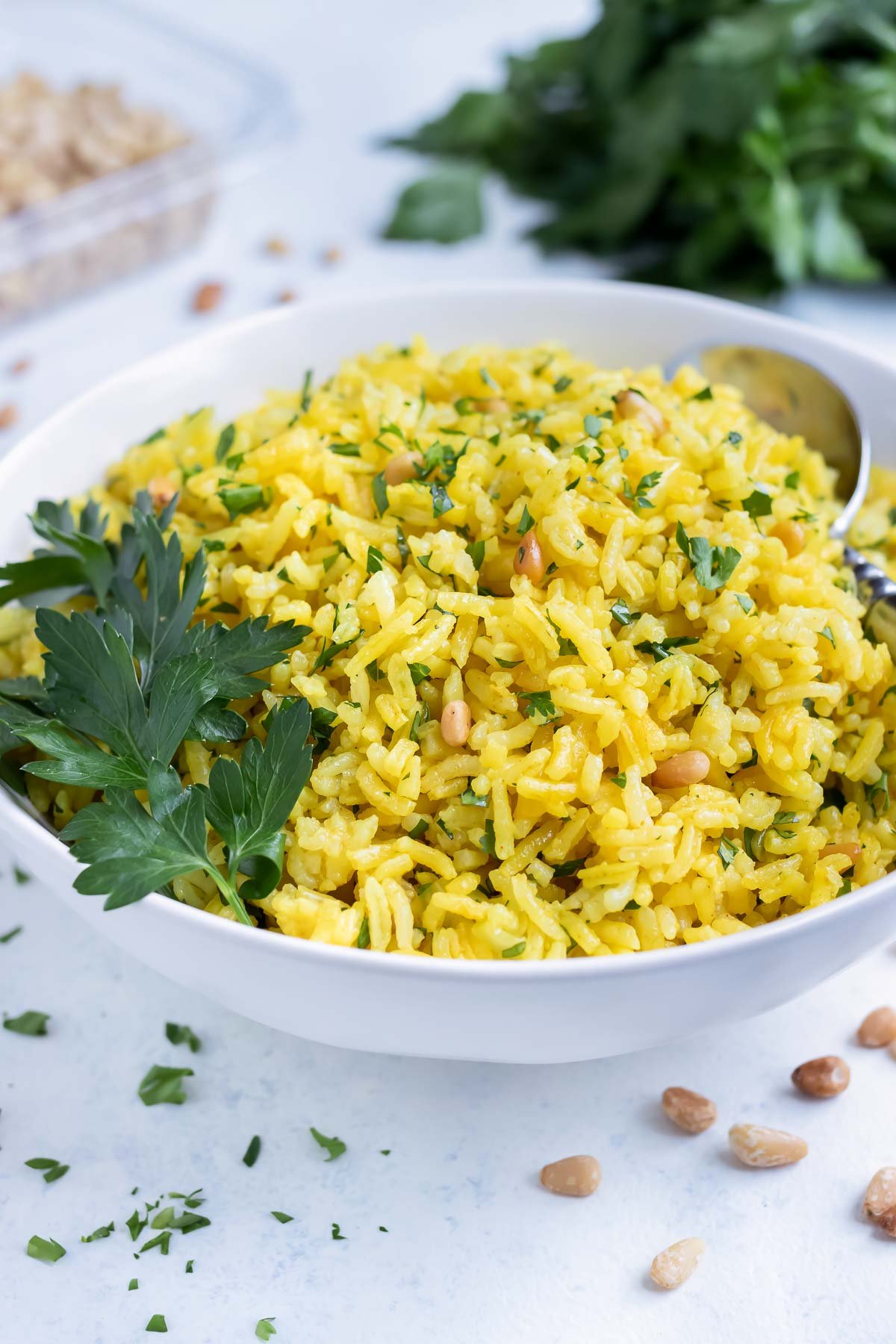 Mediterranean Yellow Rice is served from a bowl on the counter.