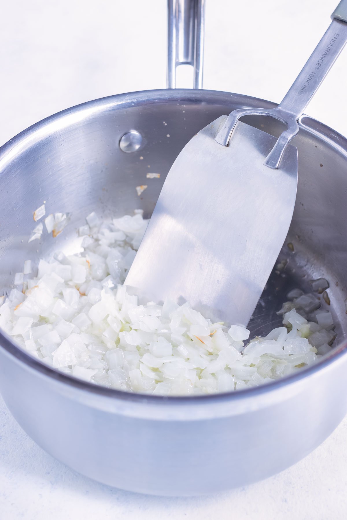 Onion and garlic are sauteed in a pot.
