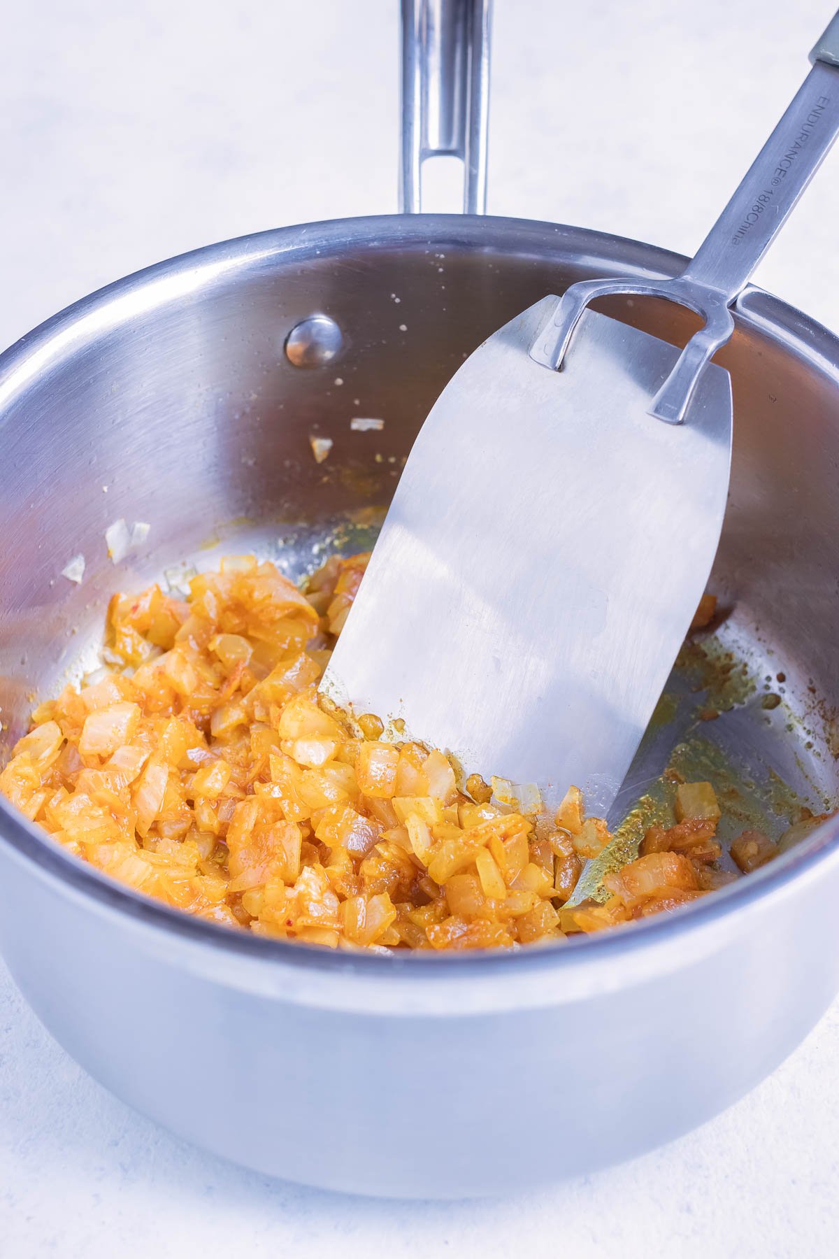 Seasonings are added to the onion.