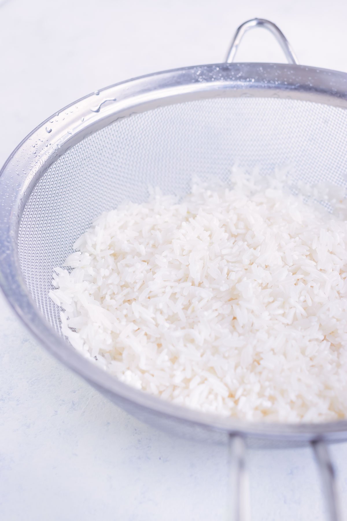 Rice is rinsed before adding to the pot.