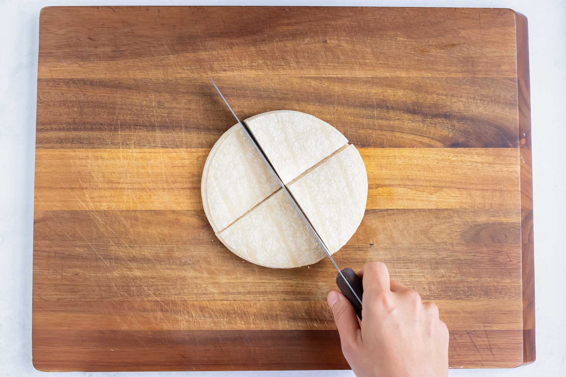 Corn tortillas are cute into four triangles.