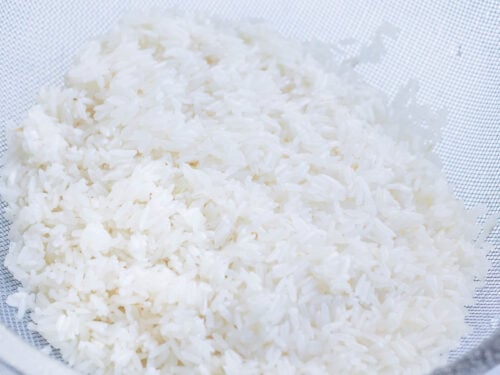 Rice is rinsed in the sink before cooking.