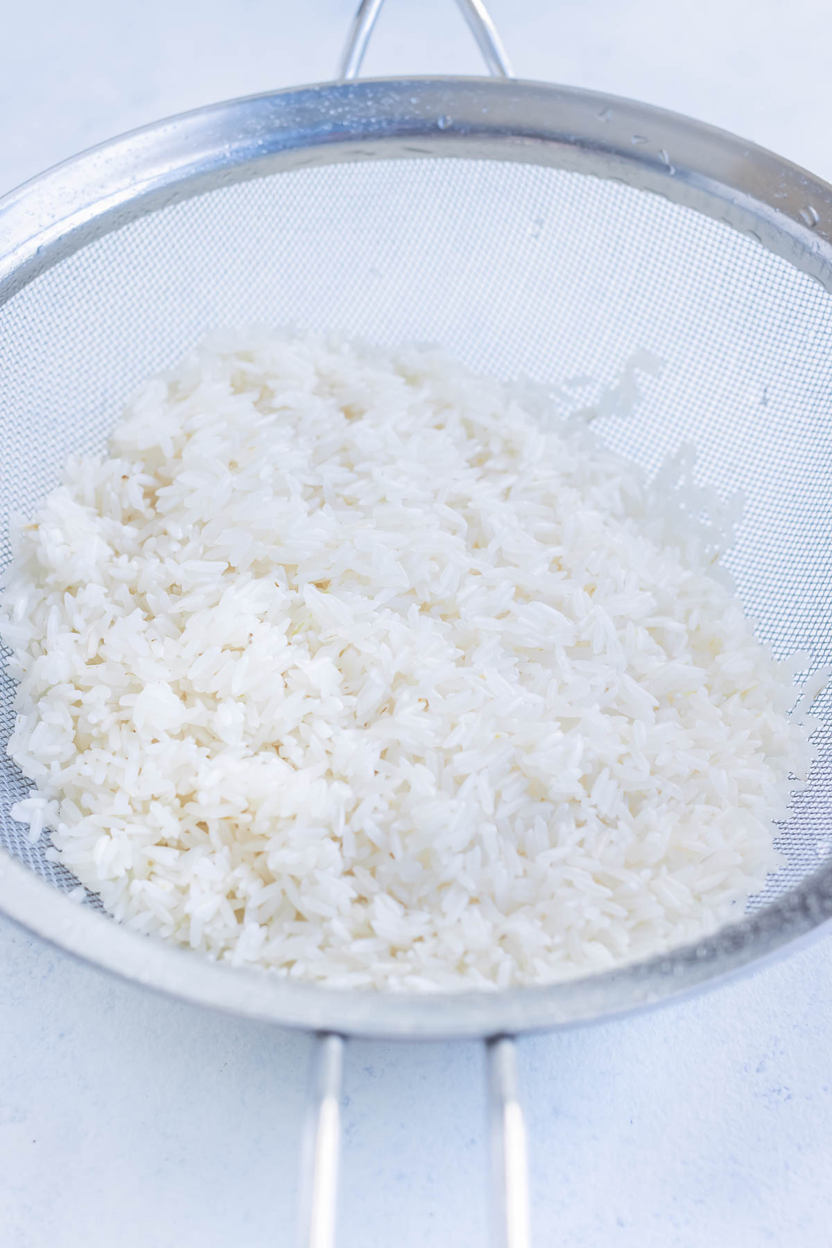 Rice is rinsed in the sink before cooking.