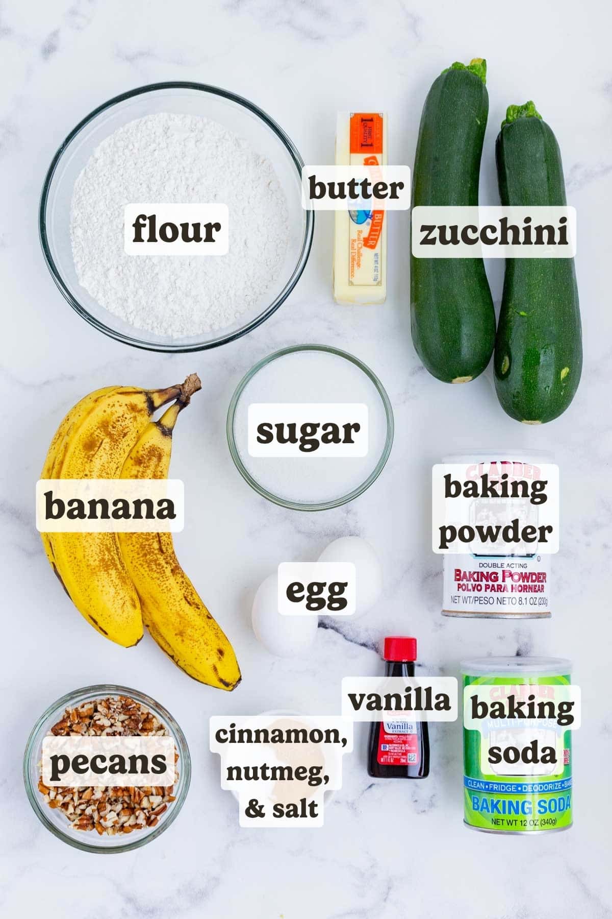 Zucchini, bananas, flour, sugar, butter, eggs, and spices are the ingredients for this bread.