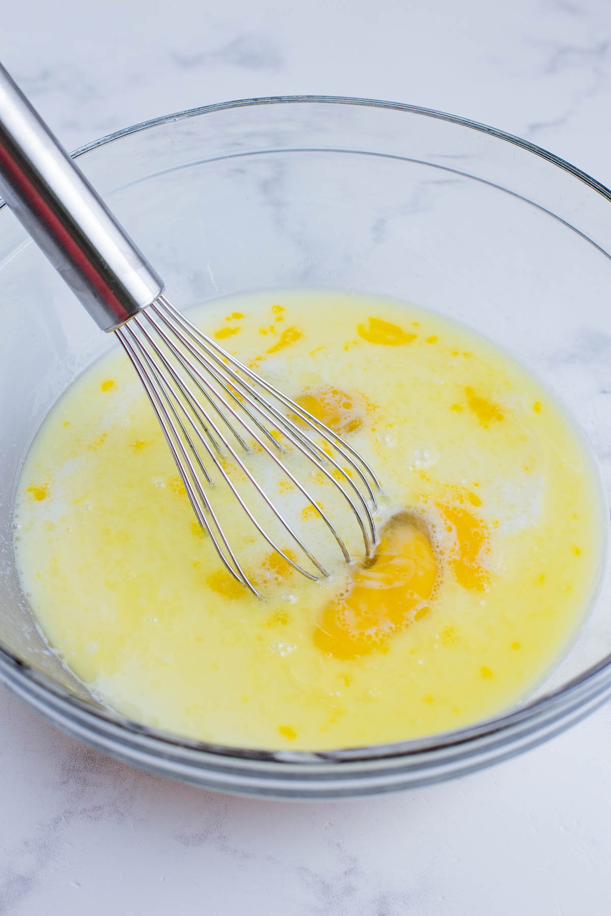 Eggs and milk are whisked together.