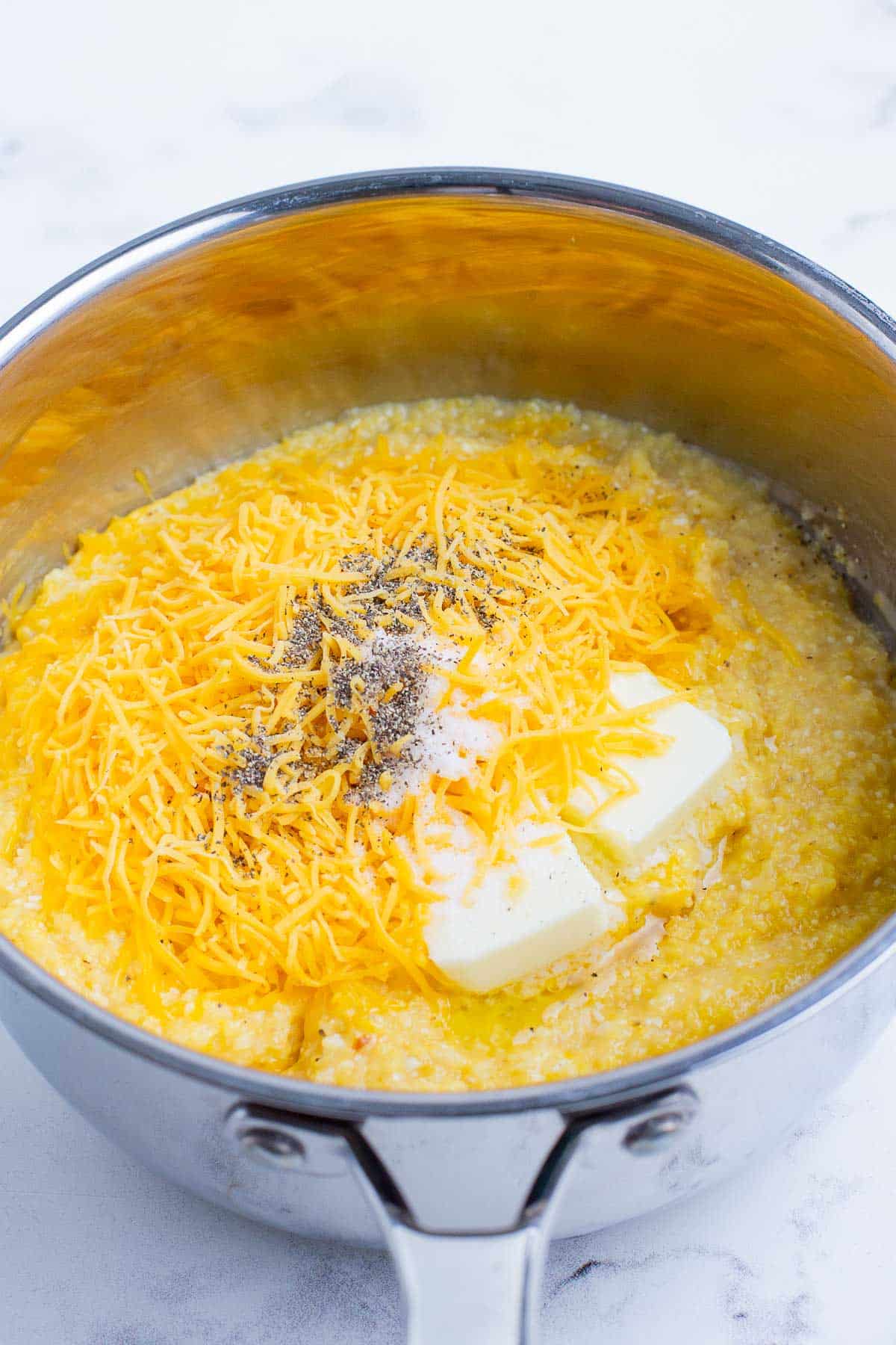 Grits ingredients are cooked in a saucepan.