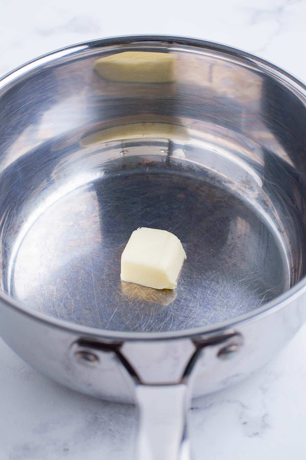 Butter is cooked in a saucepan.