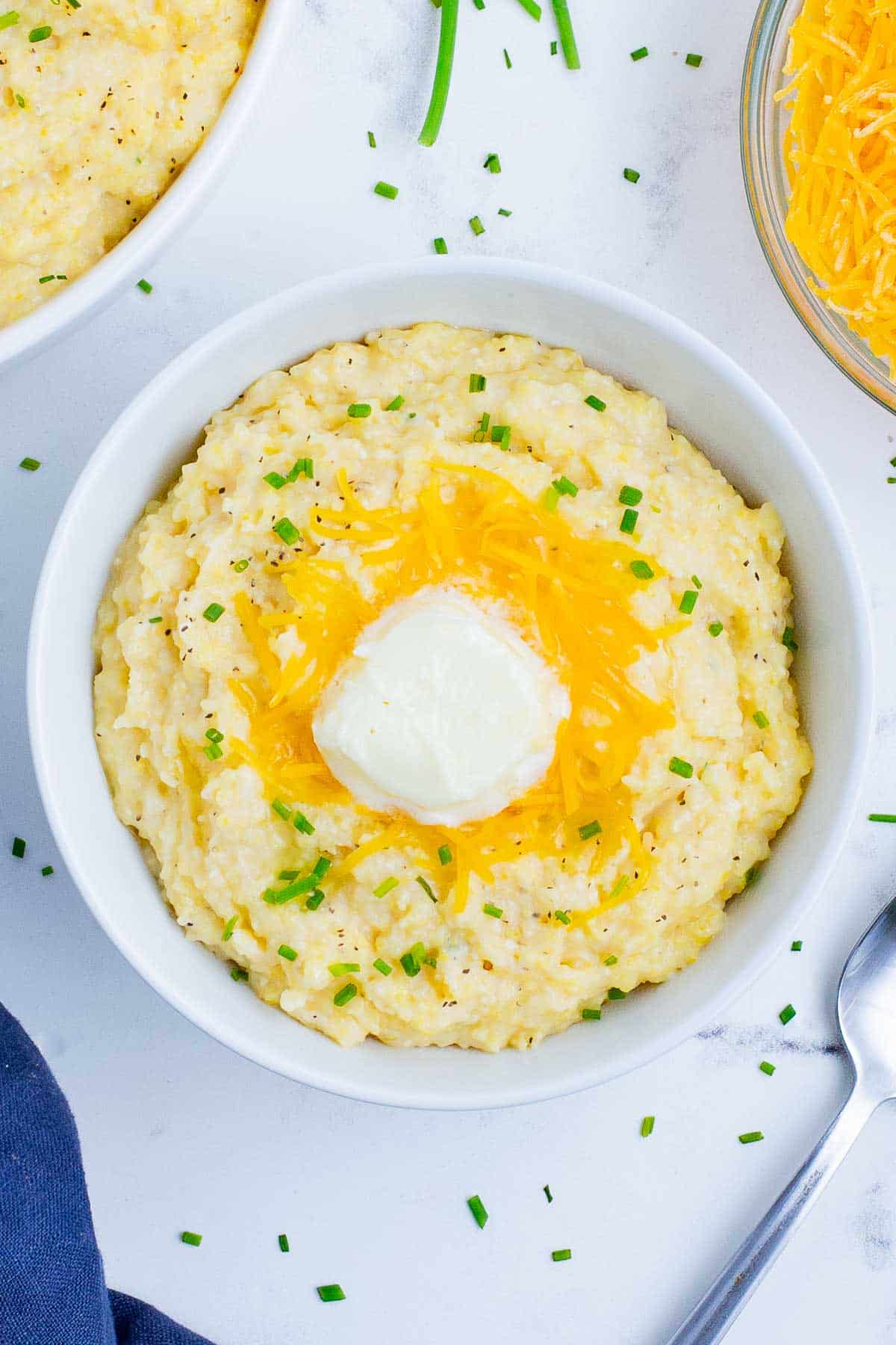 Gluten-free grits with cheese in a white bowl.