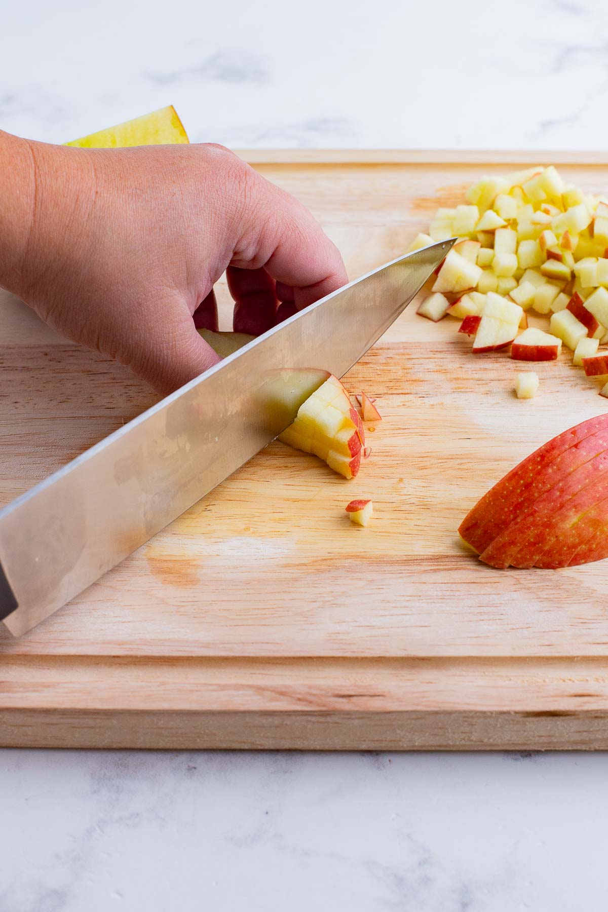 An apple is sliced before being added to the mix.