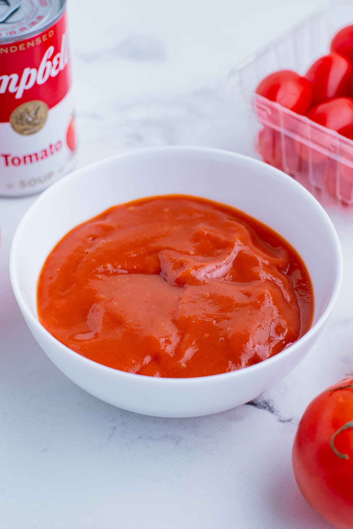 Campbell's tomato soup in a clear glass bowl.