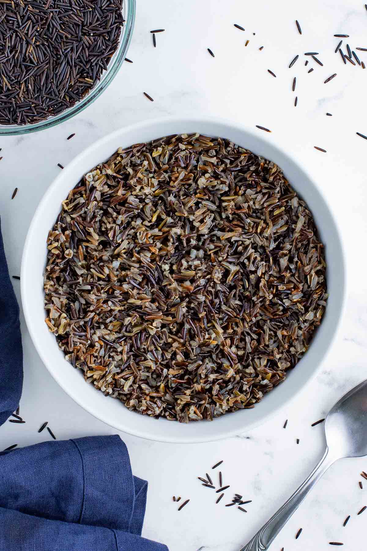An overhead view of wild rice in a white bowl.