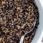 A spoon scoops up cooked wild rice for a healthy side dish.