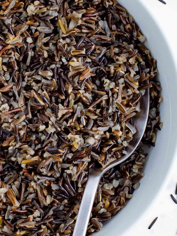 A spoon scoops up cooked wild rice for a healthy side dish.