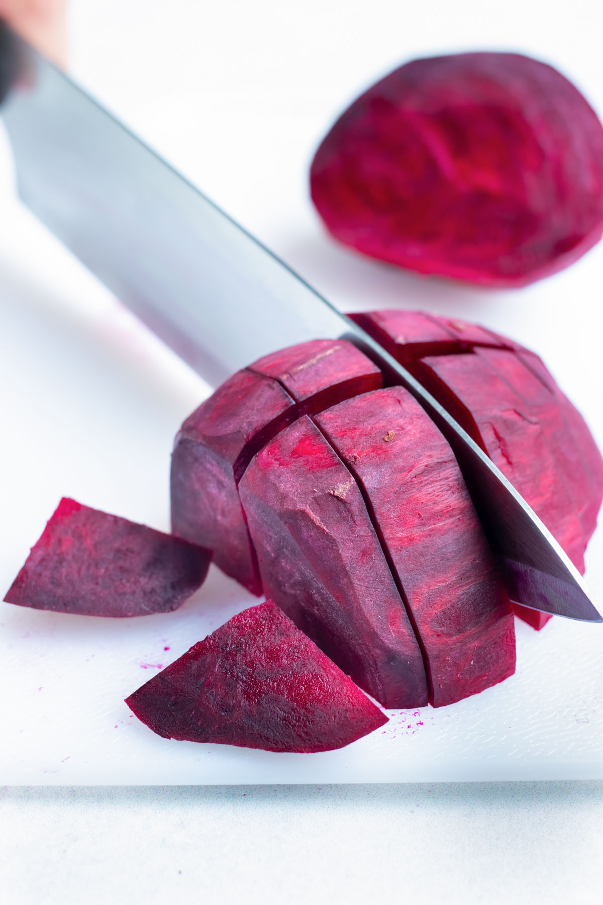 The whole beets are chopped before roasting in the oven.