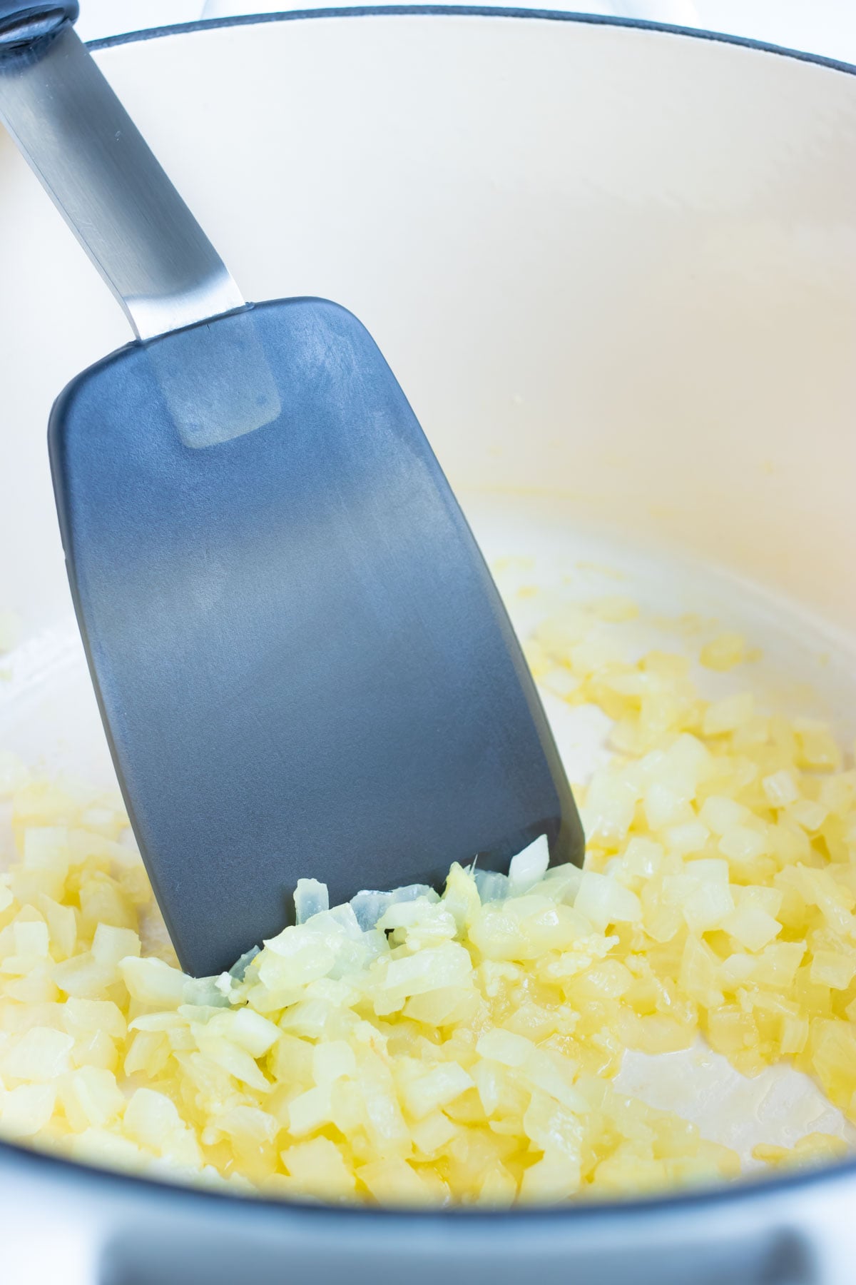 Chopped onion sautéing in a Dutch oven to start this easy beet soup recipe.